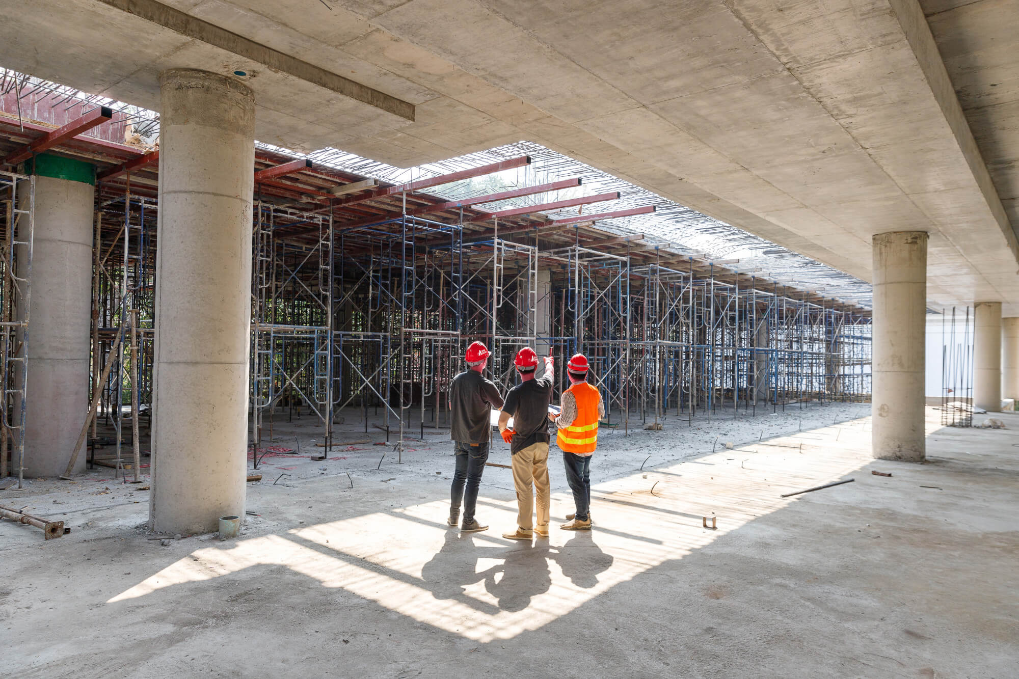 Construction workers on site discussing a project